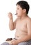 Obese boy eat chocolate isolated on white