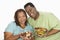 Obese Couple Holding Bowl Of Salad