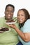 An Obese Couple Holding Plates Of Pastries