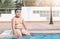 Obese fat boy sit on swimming pool