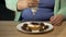 Obese female adding too much chocolate to pastry, overeating sugar and sweets