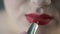 Obese female applying red lipstick and preparing for date with boyfriend