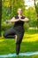 Obese girl stretches in park, daily routine for losing weight