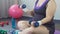 Obese lady actively lifting dumbbells to have strong arm muscles, workout