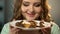 Obese lady looks with hungry eyes at sweets under chocolate dressing, overweight