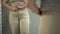 Obese lady trying to button tight pants, overweight body problem, closeup