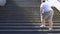 Obese man climbing stairs, overweight causes pain in joints, varicose veins