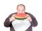 Obese man eating watermelon