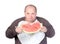 Obese man eating watermelon