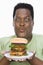 An Obese Man Looking At Hamburger