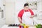 Obese man using a tablet and preparing salad