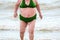 Obese woman on the beach.