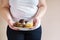 Obese woman eating sweets holding plate of cookies