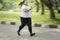 Obese woman sprinting on the road