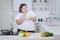 Obese woman tasting a bowl of healthy salad