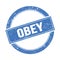 OBEY text on blue grungy round stamp