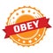 OBEY text on red orange ribbon stamp