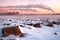 Obi beach with big stones on a pink sunset