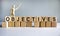 `Objectives` written on wood blocks. Business concept. Wooden model of human. Copy space. Beautiful white background
