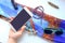 Objects of female life on a white table, phone, brooch, color scarf