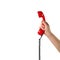 Objects Hands action - Hand holds retro phone red handset. Isolated