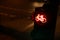 oblique closeup view on traffic light for a cycling lane showing red bicycle symbol at night with car lights in background