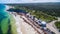 Oblique Landscape aerial view of 4WD and modern caravan parked adjacent to a sparkling sunny beach