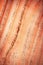 Oblique lines on red tinted wood