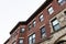 Oblique view of an old urban apartment building with carved mouldings and classic architectural details