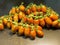 Oblong cherry tomatoes on vine on brown dark wooden table