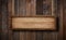 Oblong wooden sign hanging on ropes with wood planks background