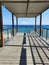 Observation deck over Fig Tree Bay beach overlooking an island in the Mediterranean Sea and a blue sky with clouds