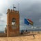 Observation deck on the Watch tower Torre de la Vela in spainish of Alcazaba with bell, tourists and flags