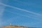 Observation tower and contrails of airplanes in the sky.