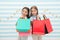 Obsessed with shopping and clothing malls. Discount concept. Kids cute girls hold shopping bags. Shopping discount