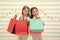 Obsessed with shopping and clothing malls. Discount concept. Kids cute girls hold shopping bags. Shopping discount