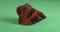 Obsidian mahogany. Igneous rock. Panorama on a green background.