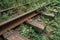 Obsolete abandoned rusty railway, overgrown with wild grass on old railroad tracks