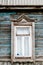 Obsolete blue wall and old wooden window. Russian traditional style