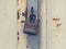Obsolete padlock lock industrial gate door. Weathered yellow gray paint