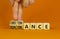 Obstinance or ignorance symbol. Businessman turns cubes, changes the word ignorance to obstinance. Beautiful orange table, orange