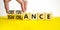 Obstinance or ignorance symbol. Businessman turns cubes, changes the word ignorance to obstinance. Beautiful yellow table, white