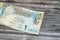 obverse side of 1 Qatari Riyal cash money currency of Qatar banknote features Ornated column, arches, sailboats, palm trees,