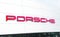 OCALA, FLORIDA USA - January 3, 2024 Porsche dealership with red logo on front of building . Florida