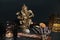 Occult altar with figurine of god Ganesha, candles, aroma stick, stones, dry herbs. Black background.