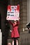 Occupy Movement protester holding poster at Bank, London, UK.