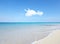 Ocean, Bahamas and blue sky for holiday, sand and rocks in shore for peace and tranquility. Seaside, waves and summer