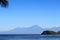 Ocean bay with rocks and blue mountains, Sumbawa island, Indonesia