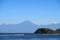 Ocean bay with rocks and blue mountains, Sumbawa island, Indonesia