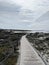 Ocean beach California  sand rock wooden walkway to the beach